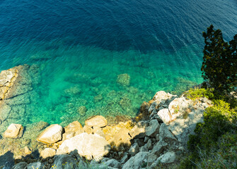 Closeup of rocks protruding from the water, top view, summer, Adriatic Sea