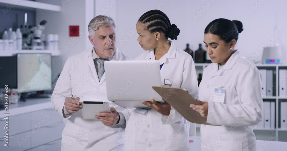 Fototapete Team of scientists discussing and recording their research on wireless devices and writing notes in a laboratory. Researchers curing diseases and developing cures in a science lab