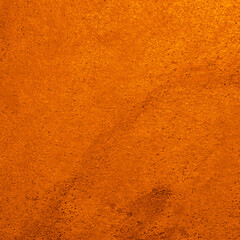 Texture of stone surface painted in orange color as background