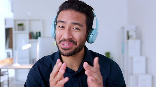 Cool influencer, journalist or podcast host wearing headphones and talking while broadcasting news. Excited, confident young man hosting online video conference and promoting on air from home studio
