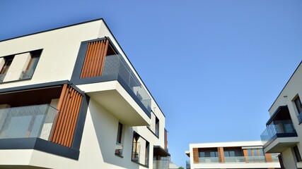 Exterior of new apartment buildings on a blue cloudy sky background. No people. Real estate business concept.