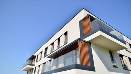 Exterior of new apartment buildings on a blue cloudy sky background. No people. Real estate...