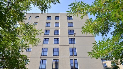 Exterior of new apartment buildings on a blue cloudy sky background. No people. Real estate business concept.