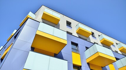 Exterior of new apartment buildings on a blue cloudy sky background. No people. Real estate business concept.