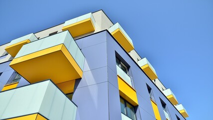 Exterior of new apartment buildings on a blue cloudy sky background. No people. Real estate...