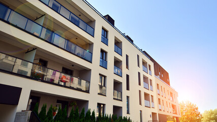 Exterior of new apartment buildings on a blue cloudy sky background. No people. Real estate business concept.