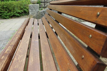 Fototapeta na wymiar wooden long bench in the park