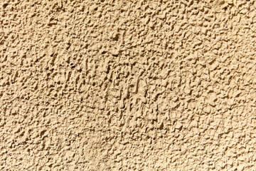 Decorative plaster on the wall of the house as an abstract background.