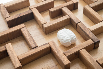 Human brain find search the exit way in wooden maze game background. Business problem solution for...