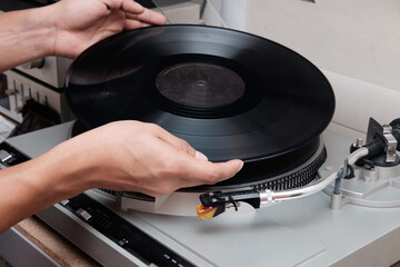 close up of a dj playing on a turntable