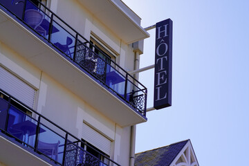 hotel text on the facade and the balcony of the hotel building