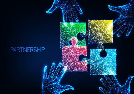 Partnership, teamwork business concept with colorful puzzle pieces and human hands on dark blue
