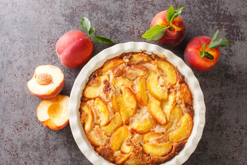 Simple and healthy  baked peach cobbler closeup in the baking dish on the concrete gray table....