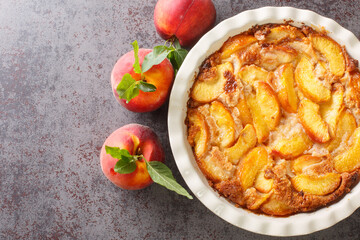 Oven baked perfect Southern dessert Peach Cobbler over concrete gray background. Horizontal top view from above