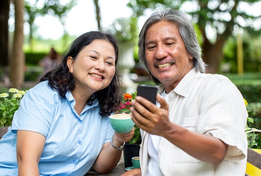 Happy Asian senior couple spending time having video call or Video Conference with family, social distancing Prevent the spread of the covid-19 virus, work from home