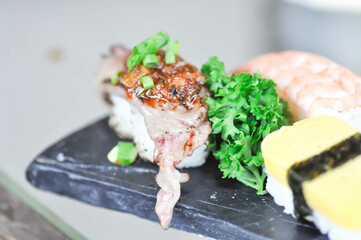 sushi or gyuuniku sushi , rice topped with raw beef or beef sushi