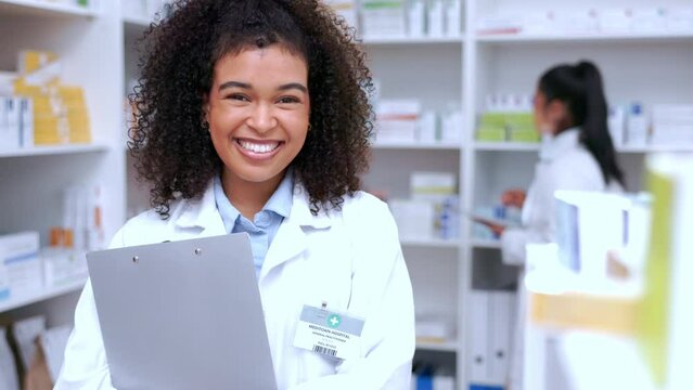 Portrait Of A Happy Pharmacist Working In A Chemist. Face Of A Beautiful Young Female Healthcare Worker And Pharmacy Assistant Taking A Break From Stocktake And Dispensing Prescription Medication.