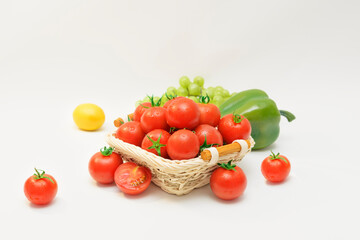 the cherry tomatos put in basket and lemon, green pepper 