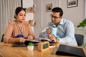 Indoor shot of an Asian Indian male and female or mixed Gender formal corporate employees or...