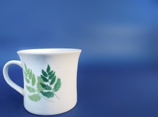 white cup on blue