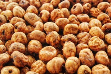 Close-up of chufa, tigernut, earth almond from Alboraya preparing for traditional typical tasty homemade drink horchata from Valencia, Spain. Healthy organic food concept. Tiger nut for flour and milk