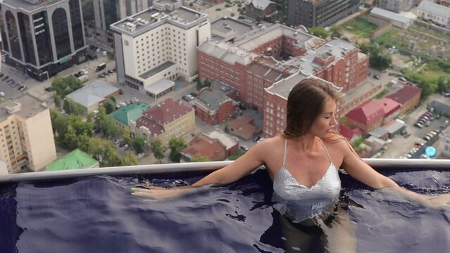 Attractive woman in swimming pool on roof