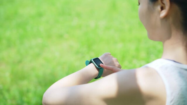 屋外でスマートウォッチを使う女性