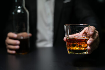 Closeup businessmen holding a glass of whiskey