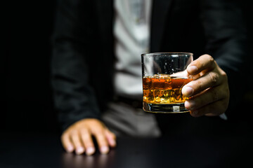 Closeup businessmen holding a glass of whiskey