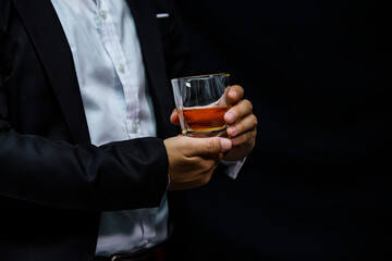 Closeup businessmen holding a glass of whiskey