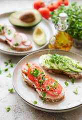Different sandwiches with vegetables and microgreens