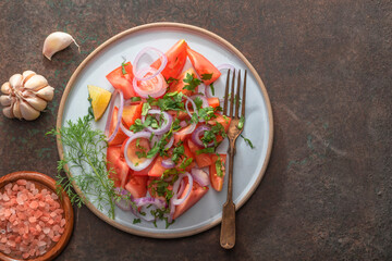 Healthy food tomato salad on metal background top view.