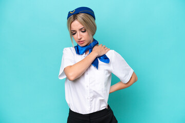 Airplane blonde stewardess woman isolated on blue background suffering from pain in shoulder for having made an effort