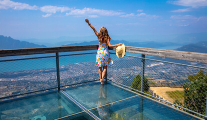 happy woman on transparent belvedere bridge panoramic view - obrazy, fototapety, plakaty