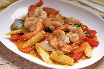Stir-fried mixed vegetables with shrimp. In a white plate, healthy food concept.