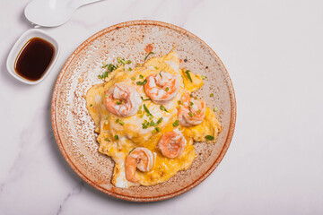 Creamy omelette with shrimps on rice served fish sauce, Thai style