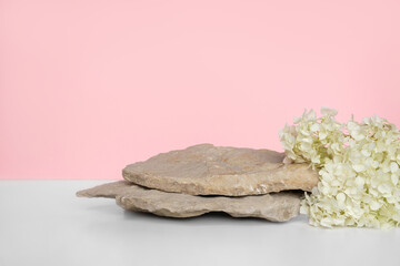 Stone Podium with flowering hydrangea branches for product presentation. Abstract minimal natural...