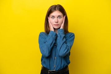 Young English woman isolated on yellow background frustrated and covering ears