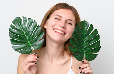 Young English woman holding a palm leaf with happy expression. Close up portrait