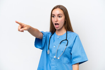 Young nurse woman over isolated on white background pointing away