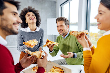 A cheerful group of colleagues laughing on a lunch break at the office.