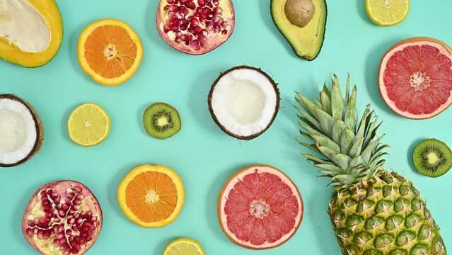 Tropic summer pattern with exotic fruits on cyan background. Stop motion flat lay
