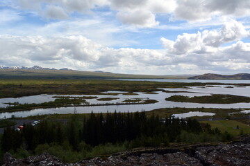 Lava field in Iceland Hrifunes  area on the background of distant mountains and stormy sky in Thingvellir area .