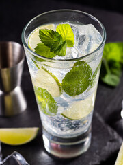 One glass of mojito cocktail with mint, lime and ice cubes