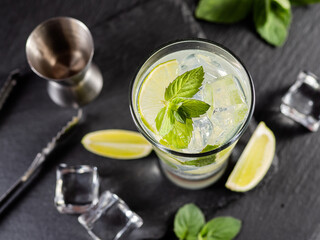One glass of mojito cocktail with mint, lime and ice cubes
