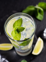 One glass of mojito cocktail with mint, lime and ice cubes