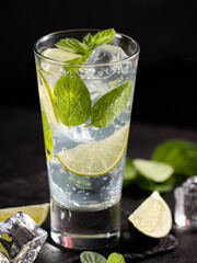 One glass of mojito cocktail with mint, lime and ice cubes