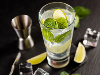 One glass of mojito cocktail with mint, lime and ice cubes