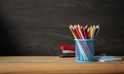 School background. Colored pencils, stapler and notepad. - obrazy, fototapety, plakaty