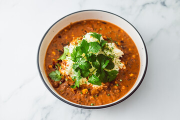 healthy plant-based food, vegan lentil and beans curry with coconut jasmine rice and coriander